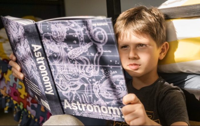 student reading an astronomy book
